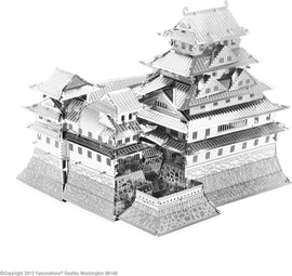 A detailed model of Himeji Castle made from metal. The structure features multiple tiers with traditional Japanese architectural elements, fanning rooftops, and intricate designs. The shiny metallic finish adds a realistic touch, showcasing the castle's complex layout and heritage.