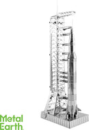 A detailed metal model of the Apollo Saturn V rocket, showcased on a launch pad. The model features intricate components, including the rocket's fins and the launch structure, all made from shiny metal. Ideal for DIY enthusiasts and space exploration fans.