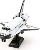A detailed Metal Earth DIY kit of the Space Shuttle Atlantis, showcasing its iconic design with a white and blue color scheme. The model is displayed on a black base labeled 'Space Shuttle ATLANTIS,' capturing its intricate features and craftsmanship, perfect for space enthusiasts and model builders.
