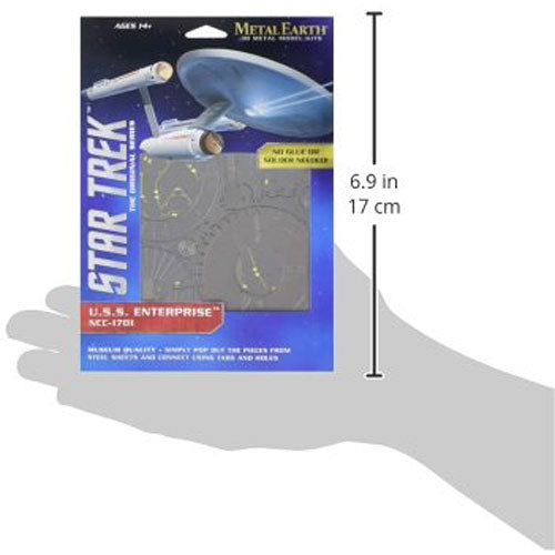 Packaging for the Metal Earth NCC-1701 DIY kit, featuring detailed metal model parts to build the U.S.S. Enterprise from Star Trek. The instructional box displays the completed model and highlights its intricate design, suitable for ages 14+. The kit emphasizes the no glue assembly process and includes measurement dimensions of 6.9 inches by 17 cm.
