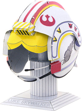 A detailed metal model of Luke Skywalker's helmet from Star Wars, designed by Fascinations. The helmet features vibrant colors like yellow, red, and white, with Rebel Alliance insignia. It is displayed on a cylindrical base, showcasing its intricate design and perfect for DIY enthusiasts and Star Wars fans.