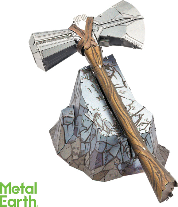 Metal Earth Stormbreaker DIY kit featuring an intricately designed metal model of the iconic axe atop a detailed rock base. The model showcases shiny metallic accents and a textured wooden handle, providing a unique crafting experience for fans of metal models and DIY projects.