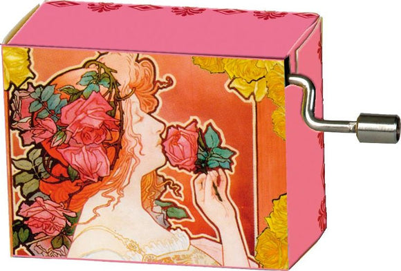 A Jugendstil Rot music box made by Fridolin, featuring an artistic design of a woman surrounded by roses. The music box has a pink background and a winding key on the side, perfect for nostalgic tunes.