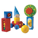 Colorful wooden blocks from HABA's First Blocks game, featuring a smiling clown figure with a blue hat, rolling wheels, and various textured shapes for sensory play. The set includes red, blue, green, and yellow blocks designed to stimulate creativity and imaginative play in children.