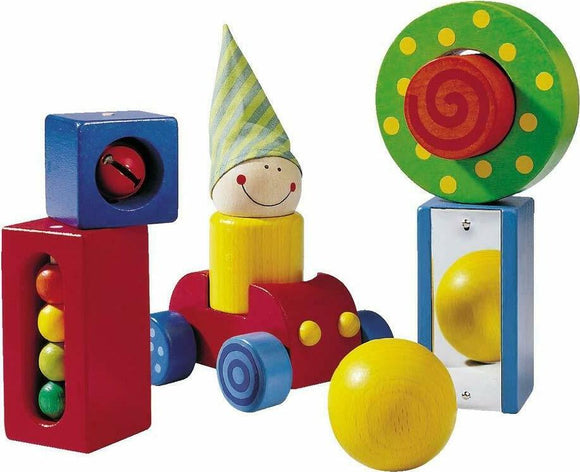 Colorful wooden toy blocks from HABA, featuring a smiling character wearing a striped hat, a car, and various shaped blocks with balls. The vibrant colors and playful design encourage imaginative play and fine motor skills development for young children.