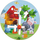A colorful mechanical motor skills game by HABA featuring a circular board with animal illustrations, including a horse, cow, and a smiling cat. The game has various colorful wooden pegs that can be inserted into different pathways, designed to help children develop fine motor skills while enjoying a playful farm theme.