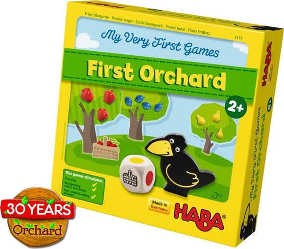 My First Orchard game by HABA USA, designed for ages 2 and up. The box features colorful illustrations of trees with apples and pears, a crow, and a dice. It emphasizes learning through play with details about stimulating free play, color recognition, and understanding rules.