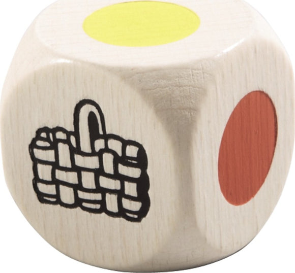 A wooden game die featuring a yellow dot, a red dot, and an illustration of a woven basket. The die is part of a children's game titled 'My First Orchard' by HABA USA, designed for preschoolers to engage in cooperative play.