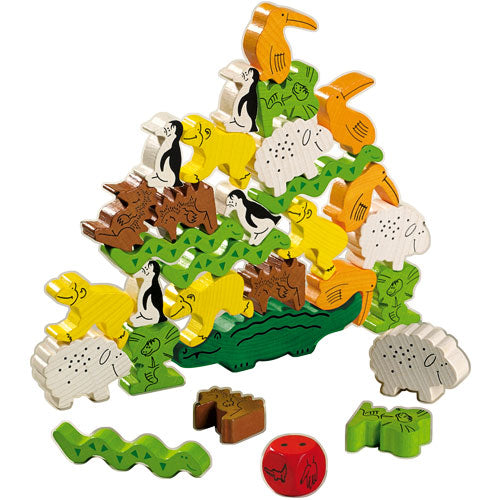 A colorful, wooden stacking game featuring various animal figures such as penguins, crocodiles, and toucans. The animals are designed in vibrant colors and textures, creating a playful, pyramid-like structure. A red dice accompanies the game, enhancing interactive play.