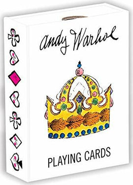 A pack of Andy Warhol playing cards featuring a colorful crown illustration on the front. The box design includes artistic symbols like hearts, diamonds, and clubs along the side, showcasing a blend of pop art style and classic card motifs.