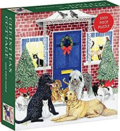The Christmas Cottage jigsaw puzzle by Galison features a festive scene with various dogs and cats gathered in front of a cozy brick cottage, decorated with a wreath and surrounded by snow. This 1000-piece puzzle is perfect for family gatherings or cozy winter evenings.