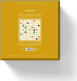 A vibrant yellow box design for the 'Sudoku With Some Balls' game by Chronicle Books. The back of the box features a colorful grid of dots in various sizes and colors, demonstrating the game's playful yet challenging nature. The brand 'Brass Monkey' is prominently displayed at the top, and instructions are included, emphasizing its fun and interactive experience.