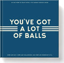 Cover of the 'Sudoku With Some Balls' game by Chronicle Books. The cover is blue with cream-colored text that reads 'YOU'VE GOT A LOT OF BALLS'. It indicates that the book contains over 100 Sudoku puzzles of varying difficulty levels.