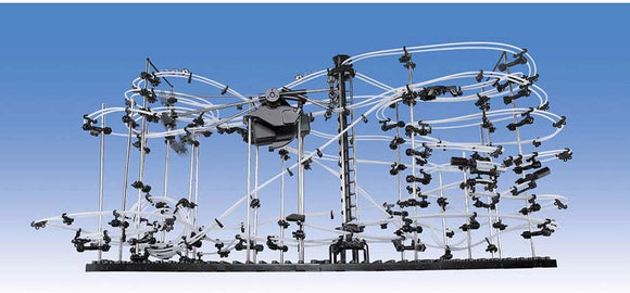 The Star Coaster Level 5 by Invento is a complex track system featuring various loops, twists, and turns made of transparent tubes and black connectors. It showcases intricate designs and mechanisms, encouraging creativity and engineering skills. The background is a bright blue sky, highlighting the structure's details.