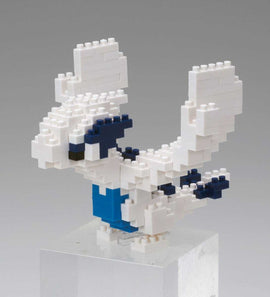 A detailed assembly of a Nanoblock Lugia, a small, intricately designed model in white and blue colors, resembling the iconic Pokémon character. The figure captures Lugia's majestic wings and sleek body, showcased on a clear base, perfect for display.