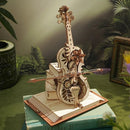 The Magic Cello Music Box is a beautifully crafted DIY kit featuring intricate woodwork that forms a miniature cello atop a book. It includes gears and floral accents, functioning as both an artistic model and a music box. The design showcases fine details in a natural wood finish, ideal for music enthusiasts and crafting lovers.