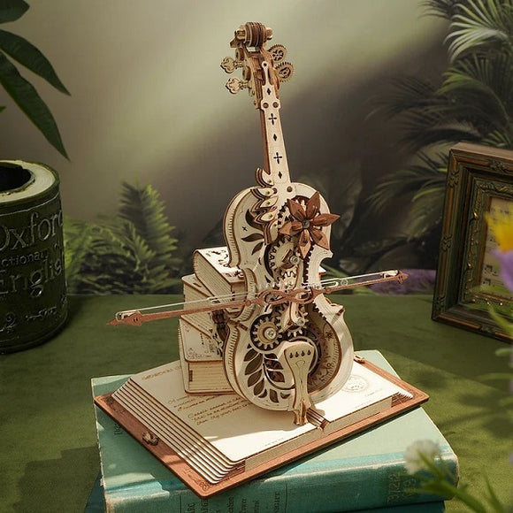The Magic Cello Music Box is a beautifully crafted DIY kit featuring intricate woodwork that forms a miniature cello atop a book. It includes gears and floral accents, functioning as both an artistic model and a music box. The design showcases fine details in a natural wood finish, ideal for music enthusiasts and crafting lovers.
