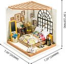 A detailed model kit of a dreamy bedroom, featuring a bed with colorful bedding, a decorative mirror, a bookshelf filled with books and accessories, a cozy corner chair, and a large window that floods the space with natural light. The room showcases a warm color palette with floral accents and artistic decor elements, making it an inviting and creative DIY project.