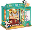 Alice's Tea Store DIY kit by Robotime featuring a whimsical tea shop with intricate details like a rabbit figure, a decorated counter with tea sets, and a beautifully crafted exterior. The colorful design is inspired by the magical world of Alice in Wonderland, perfect for crafting enthusiasts.
