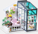 The Fancy Balcony Daydreaming Model Kit by Robotime showcases a beautifully designed miniature balcony scene. It features a cozy purple armchair, decorative plants, colorful shelves, and various craft supplies, creating an inviting atmosphere ideal for DIY enthusiasts. The intricate details include a large window and potted plants, perfect for imaginative play or display.