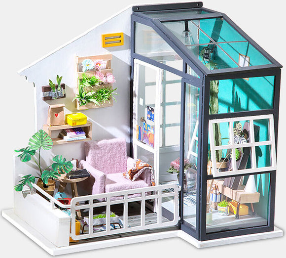 The Fancy Balcony Daydreaming Model Kit by Robotime showcases a beautifully designed miniature balcony scene. It features a cozy purple armchair, decorative plants, colorful shelves, and various craft supplies, creating an inviting atmosphere ideal for DIY enthusiasts. The intricate details include a large window and potted plants, perfect for imaginative play or display.