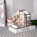 The Fancy Balcony Daydreaming Model Kit by Robotime is a beautifully crafted DIY kit featuring a miniature balcony with a cozy indoor scene. The model displays a small living space complete with stylish furniture, vibrant plants, and decorative accents. The attention to detail highlights a warm and inviting atmosphere, perfect for enthusiasts of miniature creations.