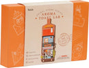 Aroma Toast Lab DIY kit by Robotime, featuring a charming miniature store model designed for both standing and wall-hanging display. The box showcases vibrant colors and illustrations, emphasizing its playful aesthetic, with a touch light feature and easy assembly instructions.