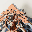 A close-up view of the Romantic Notes Wall Clock by Robotime, featuring intricately designed wooden elements with ornate detailing. The clock showcases a combination of light and dark wood finishes, with a decorative top and stylized Roman numerals, highlighting its elegant craftsmanship that blends functionality and artistry in a DIY kit.