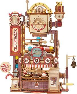 The Chocolate Factory Marble Run Model Kit by Robotime is a detailed DIY kit featuring a colorful, whimsical design. The model showcases a chocolate factory with vibrant multi-colored balls traveling through intricate pathways, candy decorations, and mechanized elements. It's perfect for crafting enthusiasts, combining creativity and engineering to create a fun, interactive display piece.