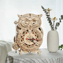The Owl Clock 3D Build Kit by Robotime is an intricate DIY kit featuring a beautifully crafted wooden owl design with a functional clock face. This mechanical clock showcases detailed gears and a pendulum, making it both a decorative piece and a fun project to assemble. The natural wood finish enhances its aesthetic appeal, perfect for home decor.