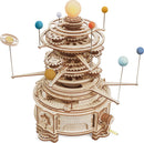 A detailed Curious Discovery Solar System Model Kit by Robotime, showcasing a multi-layered design with gears and colorful planet representations. The model features an illuminated sun at the top and planets suspended on rods, artfully showcasing the solar system's layout. Ideal for DIY enthusiasts, this kit blends creativity with educational science exploration.