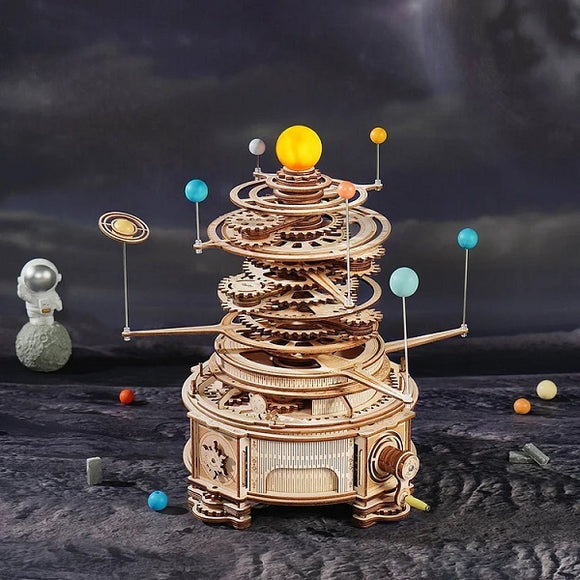 Curious Discovery Solar System Model Kit by Robotime, a DIY mechanical model showcasing a rotating solar system with planets and an intricate gear system, set against a cosmic background.