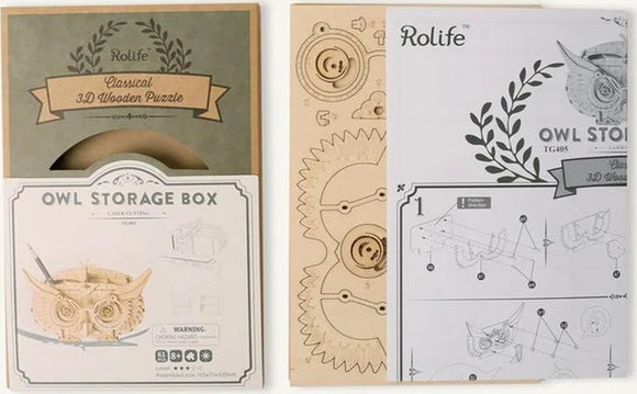 The Owl Storage Box 3D Build Kit by Robotime features a beautifully designed packaging showcasing an owl-themed storage box. The kit includes laser-cut wooden pieces and assembly instructions, perfect for DIY enthusiasts. The front of the package highlights the detailed construction illustration and the warning label, ensuring safety during the building process.
