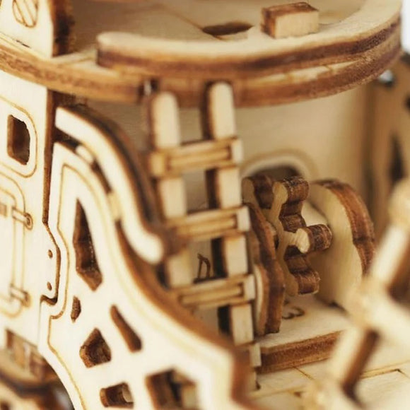 Close-up of the intricately designed Airship 3D Puzzle Kit made by Robotime. The image showcases multiple wooden gears, ladders, and layers of the assembly, emphasizing the precision and craftsmanship involved in this DIY kit. Ideal for puzzle enthusiasts, it offers a creative and engaging building experience.
