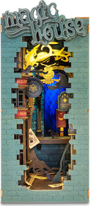 The Magic House DIY Book Nook by Robotime features a whimsical design of a magical shop scene with intricate details such as signs for 'Summoning Magic' and 'Magic Lab'. The rich blue backdrop and layered elements create a captivating three-dimensional effect, perfect for book lovers and DIY enthusiasts.