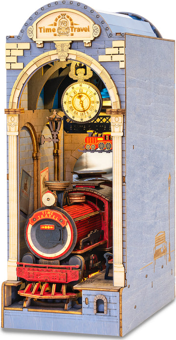 The Time Travel DIY Book Nook by Robotime is a detailed miniature construction kit featuring a vintage train station scene. The intricately designed facade showcases a red steam locomotive, vintage clock, and decorative archways, inviting enthusiasts into a whimsical world of creativity and nostalgia.
