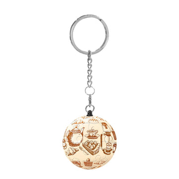 A Tea Time Puzzle Keychain by Pintoo featuring a round jigsaw puzzle design depicting various tea-related items like teapots, cakes, and pastries, attached to a metal keyring with a chain.