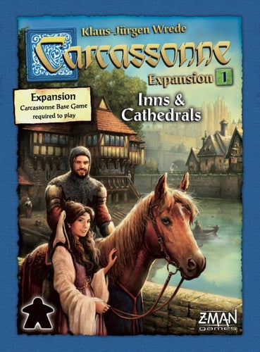 Carcassonne: Expansion 1 – Inns & Cathedrals game box featuring a medieval scene with a man, a woman, and a horse by a river. The box indicates that the Carcassonne base game is required to play. Designed by Klaus-Jürgen Wrede and published by Z-Man Games, this expansion adds new gameplay elements to the classic tile-placing game.