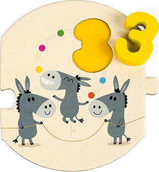 A colorful jigsaw puzzle titled 'I Learn to Count' by Janod, featuring three playful donkeys engaging in a joyful scene, surrounded by numbers and vibrant colors. The puzzle includes a removable yellow number 3 piece, emphasizing counting skills for young children.