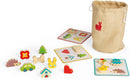 The Memory Touch Recognition Game by Janod features colorful wooden pieces shaped like animals, trees, and vehicles. These pieces can be matched to their corresponding cards, enhancing memory skills and tactile recognition in young children. The game is neatly stored in a durable, drawstring bag, making it perfect for on-the-go play.