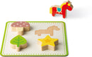 Memory Touch Recognition Game by Janod features colorful wooden shapes including a mushroom, leaf, star, and horse. Designed to enhance sensory play and memory skills in children, the game invites players to match the pieces accurately on a green-bordered base. Perfect for developing cognitive abilities while engaging in fun.