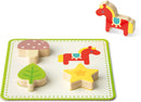 The Memory Touch Recognition Game by Janod features vibrant wooden shapes including a mushroom, horse, leaf, and star, designed to enhance children’s cognitive skills and memory. Each piece fits snugly onto a colorful board with playful artwork, perfect for young learners.