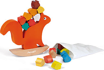 Nutty Balance Balancing Game by Janod featuring an orange squirrel figure balancing colorful wooden blocks on its back, along with a bag of additional blocks. Designed for fun and skill development, this game encourages hand-eye coordination and balance skills.