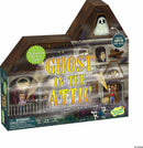 The Ghost in the Attic board game by MindWare features colorful artwork depicting children and a ghost. The box prominently displays the title in bold letters with playful graphics of a haunted house, light-up ghost mover, and characters exploring in the dark. Ideal for family game night, this cooperative game is suitable for ages 5 and up, accommodating 2-6 players and playable in about 15 minutes.