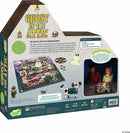 The back of the Ghost in the Attic game box by MindWare showcases the game's colorful artwork, featuring a haunted manor with a playful ghost and a dog character. The design includes game components like the board, tokens, and player figures, highlighting the cooperative nature and the skills it fosters such as strategy, teamwork, and decision-making. Two children are seen engaging in gameplay with the light-up game board, creating an inviting atmosphere for family fun.
