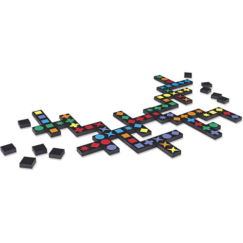 A colorful setup of Qwirkle game pieces laid out on a table. The pieces feature various shapes and vibrant colors including stars, circles, and squares, with some pieces joined together to form lines. The game enhances strategic thinking and is designed for family fun.