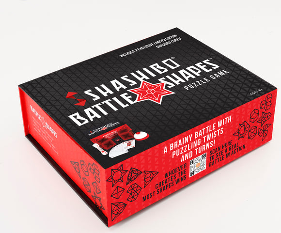 Shashibo Battle Shapes 2-pack by Geobenders features a vibrant red and black puzzle box. The design includes the product title prominently on the front, with playful geometric shapes and a QR code for additional content. The packaging invites players to engage in a 'brainy battle' with twisting and turning puzzle challenges, suitable for ages 8 and up.