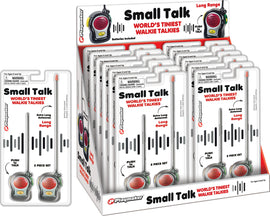 The World's Tiniest Walkie Talkies by Playmaker displayed in packaging. The set includes two small walkie talkies featuring extra long antennas for long-range communication. Each device has a push-to-talk feature and is designed for ages 6 and up. The packaging highlights key product features.