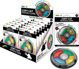 Copy Cat Memory Game by Playmaker featuring a circular device with colored light segments (red, yellow, green, blue) that challenges players to repeat sequences of lights and sounds. The packaging emphasizes memory skills, with a vibrant design suitable for ages 6 and up.