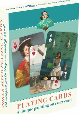 Janet Hill Playing Cards featuring unique paintings on each card, showcasing artistic designs. The box shows examples of cards with a king, an eight, and a six, each adorned with captivating illustrations. Made by New York Puzzle Company, this set is perfect for game nights and collectors.